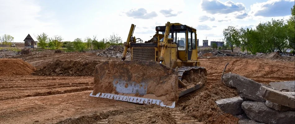 Excavator performing commercial excavation services at a construction site in Huron, OH.