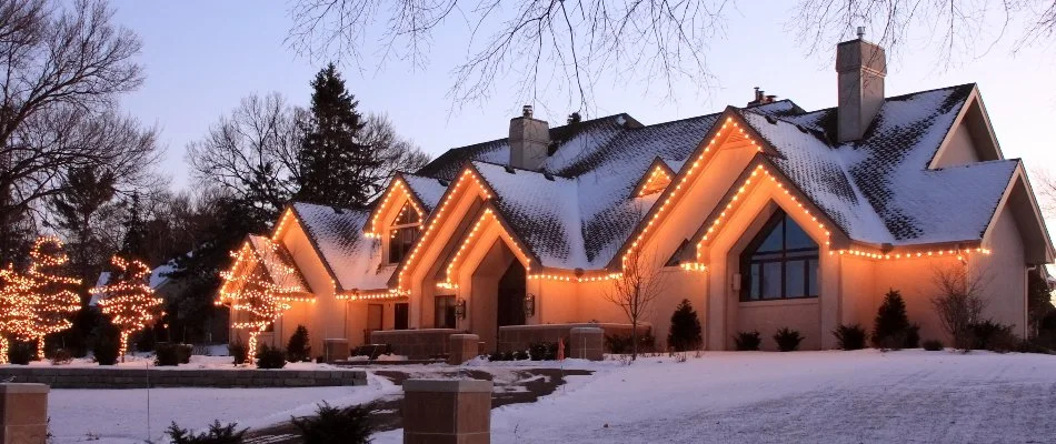 House in Huron, OH, with holiday lights on the rooflines.