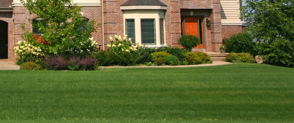 Neat lawn and landscape in Huron, OH, with shrubs and flowers.