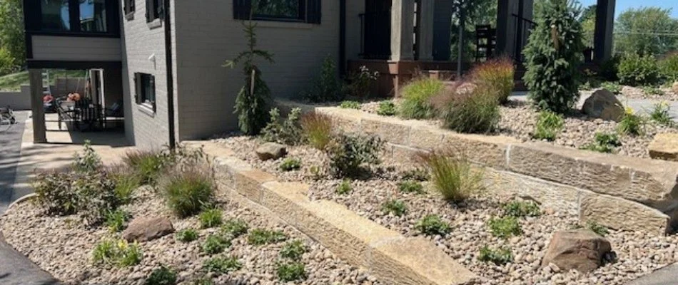 Retaining wall near a house in Huron, OH, with landscaping.