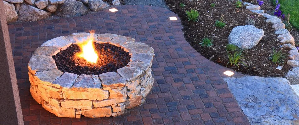 Round gas fire pit in Huron, OH, on a patio.