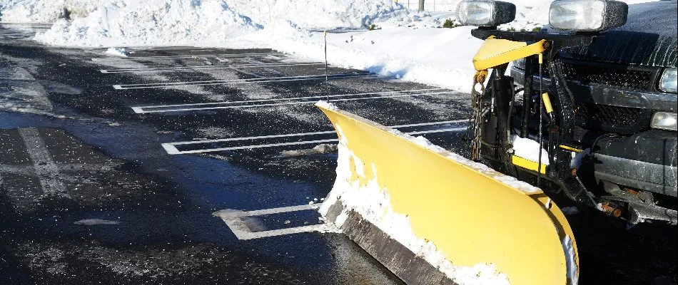 Yellow plow on a truck in a parking lot in Huron, OH.